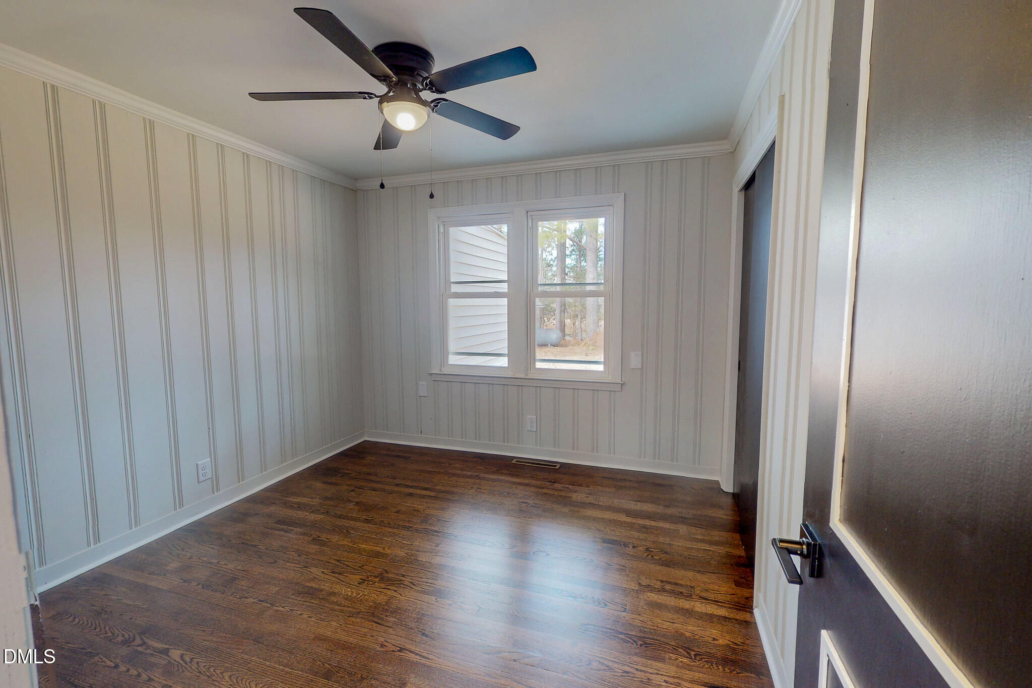 844 Holeman Ashley Road Timberlake, NC 27583 - Photo 34 of 58 an empty room with wooden floor fan and windows