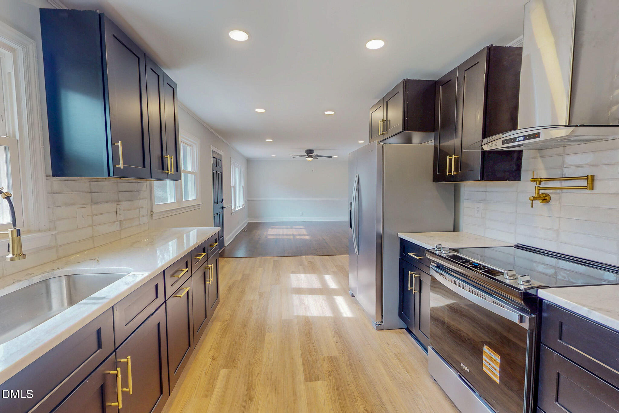 844 Holeman Ashley Road Timberlake, NC 27583 - Photo 4 of 58 a kitchen with stainless steel appliances granite countertop a sink a stove and a wooden floors