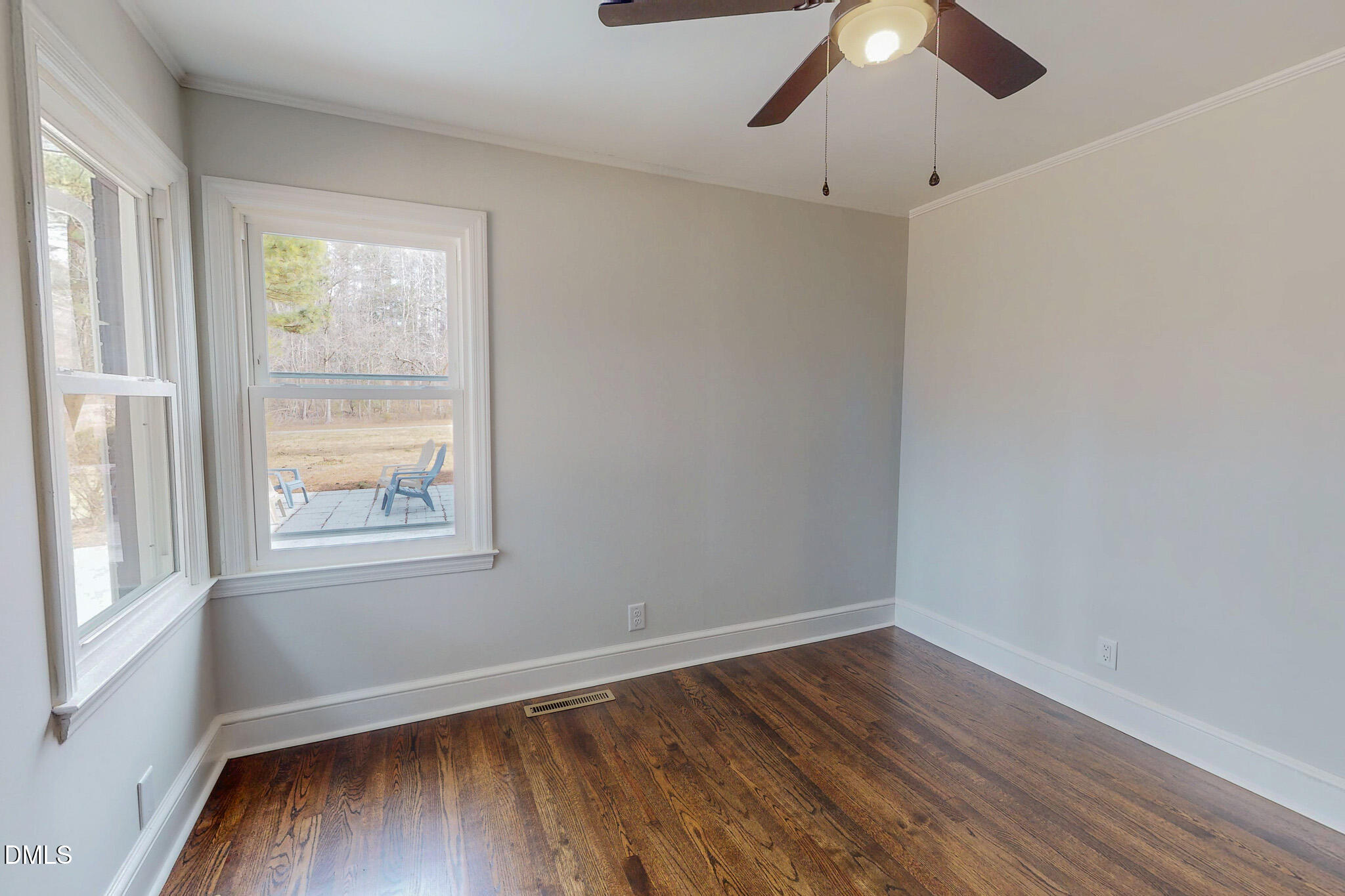 844 Holeman Ashley Road Timberlake, NC 27583 - Photo 42 of 58 an empty room with wooden floor fan and windows