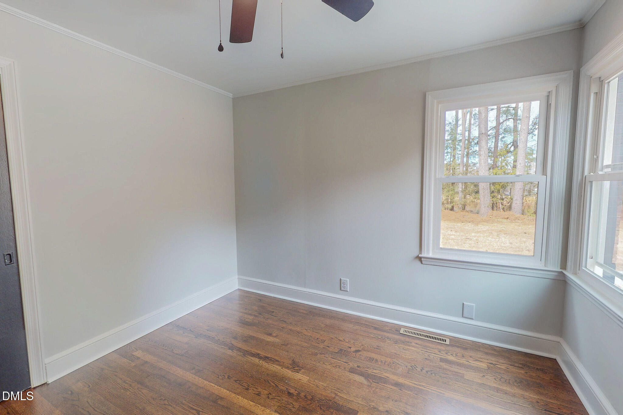 844 Holeman Ashley Road Timberlake, NC 27583 - Photo 43 of 58 an empty room with wooden floor and windows