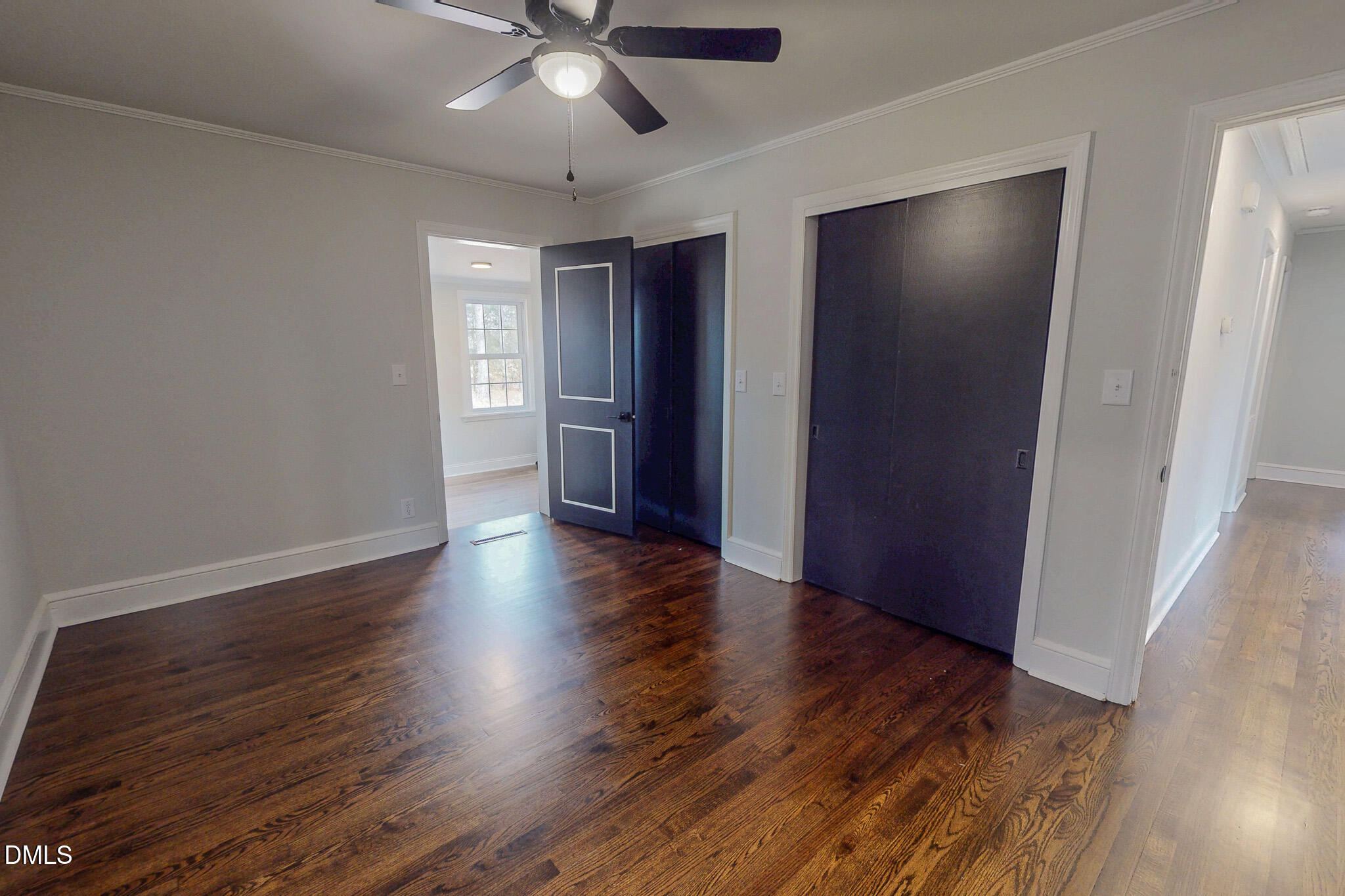 844 Holeman Ashley Road Timberlake, NC 27583 - Photo 46 of 58 a view of an empty room with wooden floor and a ceiling fan