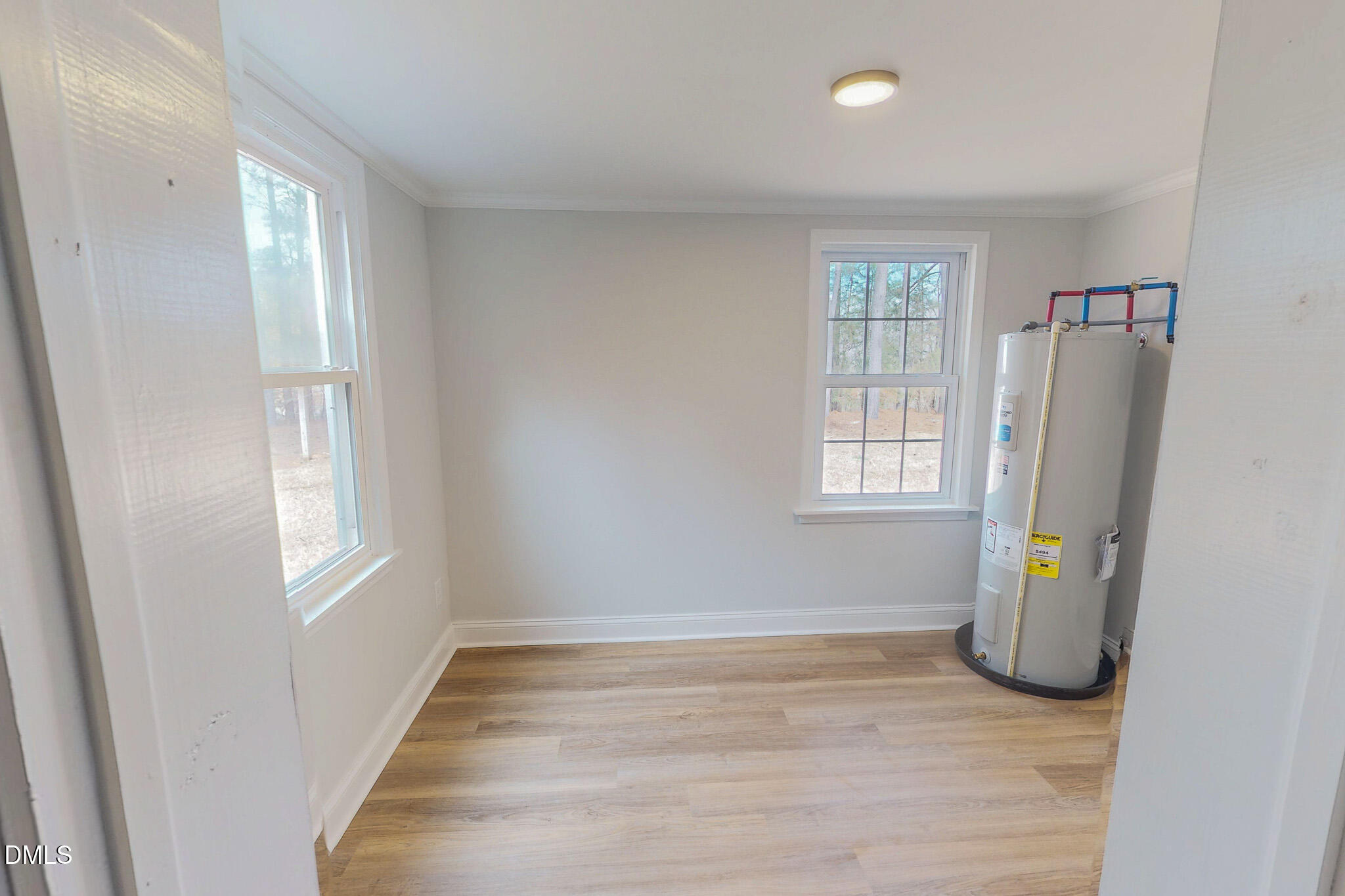 844 Holeman Ashley Road Timberlake, NC 27583 - Photo 49 of 58 a view of empty room with wooden floor and fan