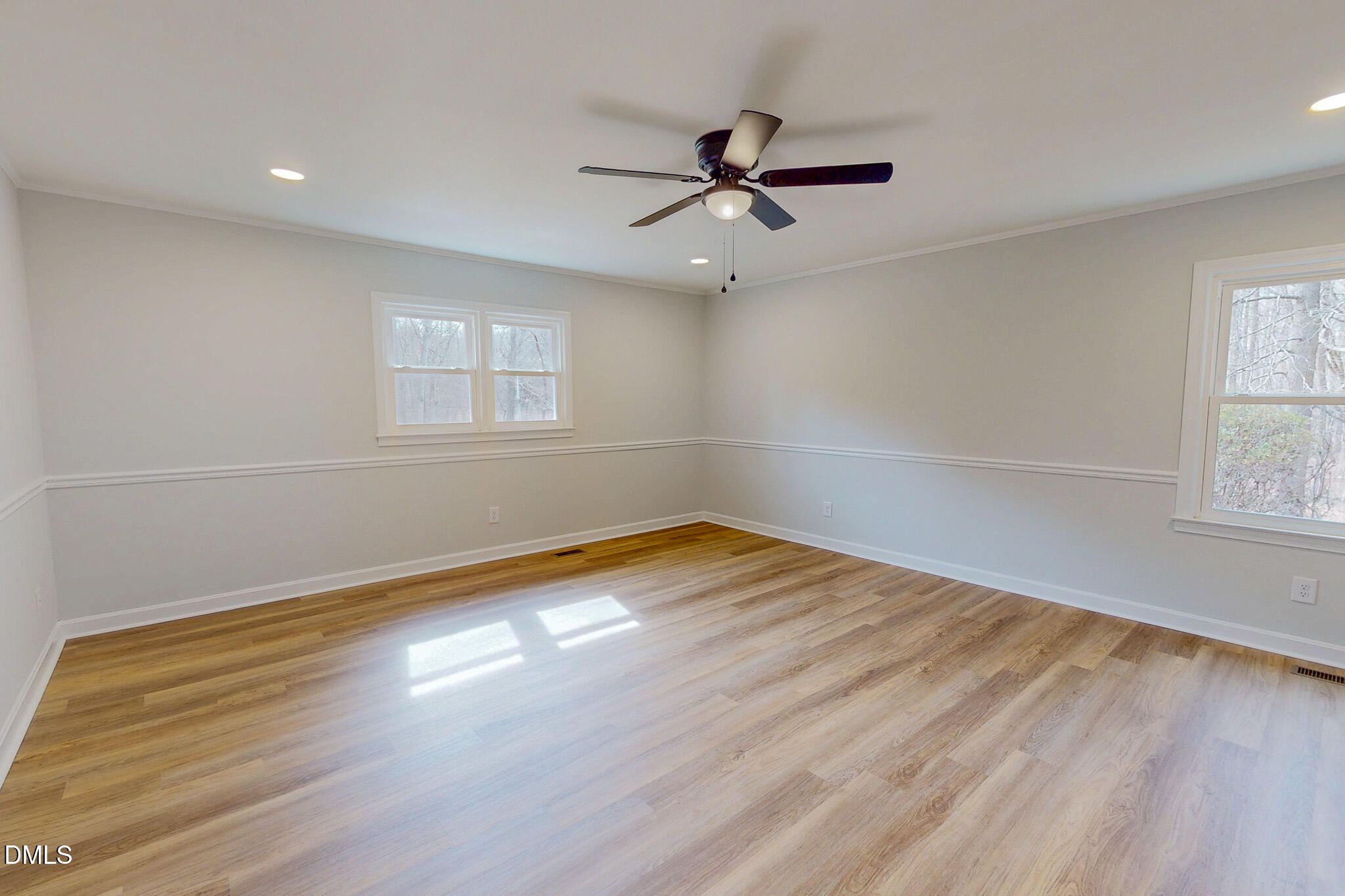 844 Holeman Ashley Road Timberlake, NC 27583 - Photo 10 of 58 an empty room with wooden floor fan and windows