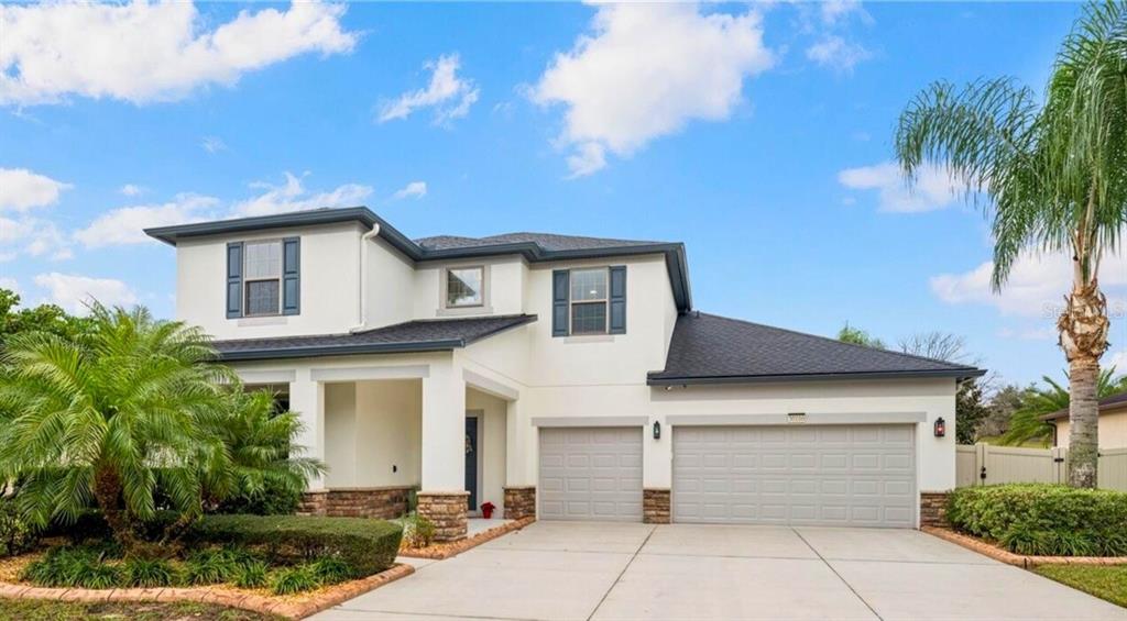 a front view of a house with a yard and garage