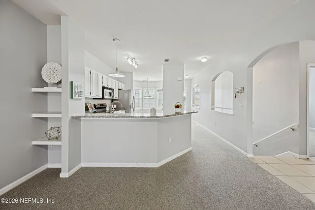 a kitchen with a sink and stainless steel appliances