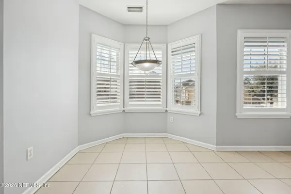 an empty room with entrance and windows