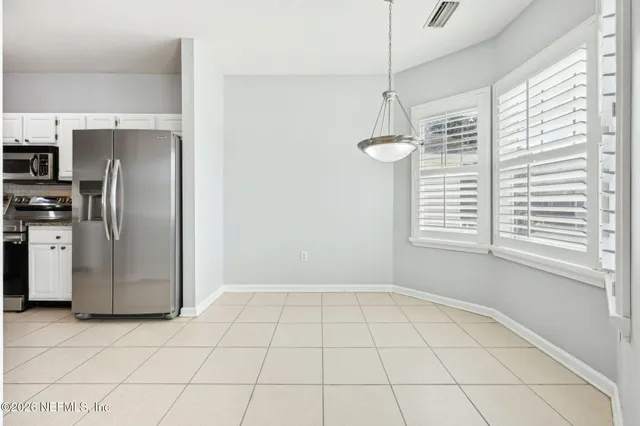 an empty room with chandelier fan