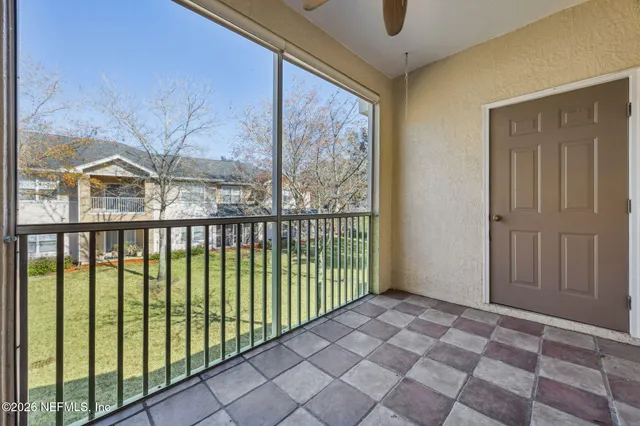 a view of a house with a big yard and large trees