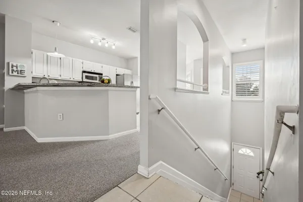 a view of a livingroom with a chandelier fan