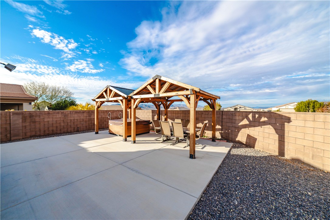 3379 Motherload Road Kingman, AZ 86401 - Photo 13 of 67 Fenced backyard featuring a patio and a hot tub