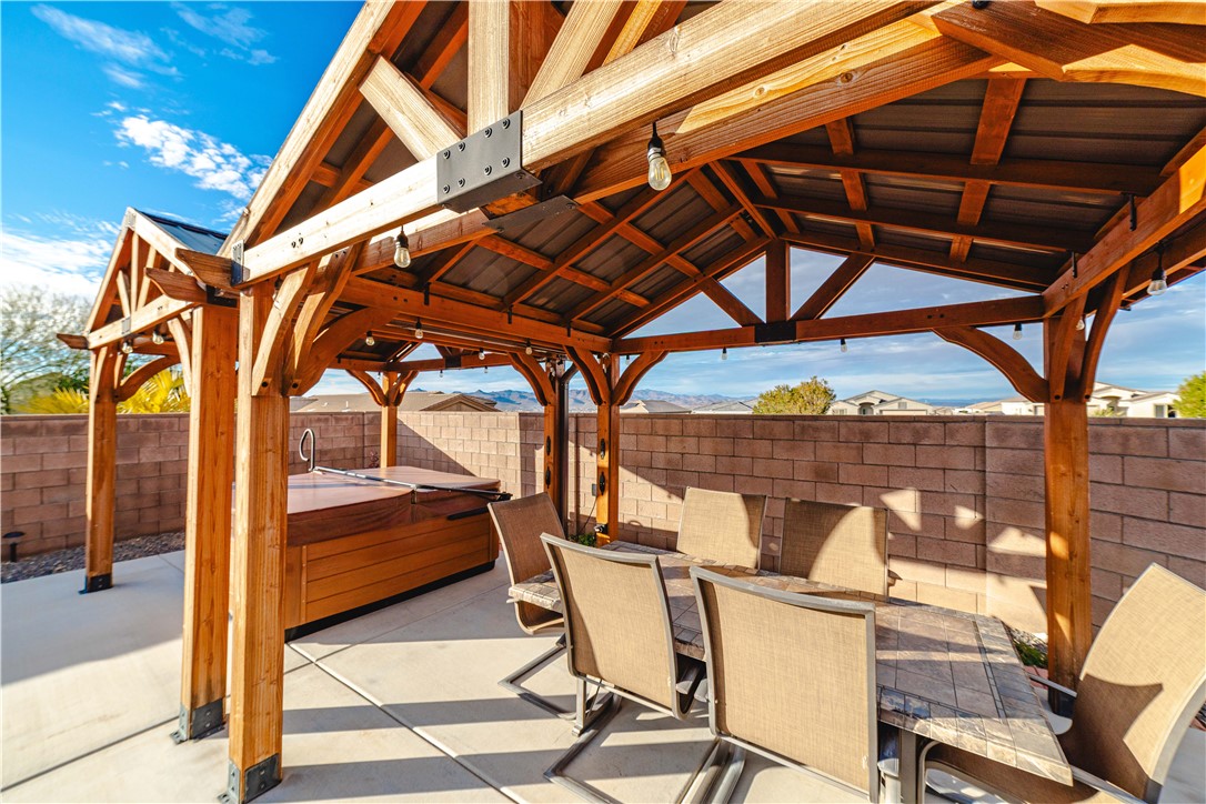 3379 Motherload Road Kingman, AZ 86401 - Photo 15 of 67 Fenced backyard with outdoor dining space, a hot tub, and a patio