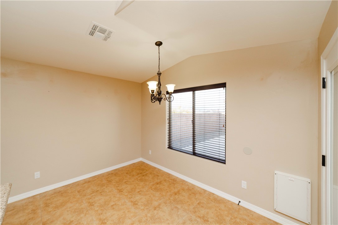 3379 Motherload Road Kingman, AZ 86401 - Photo 19 of 67 Spare room with vaulted ceiling and a chandelier