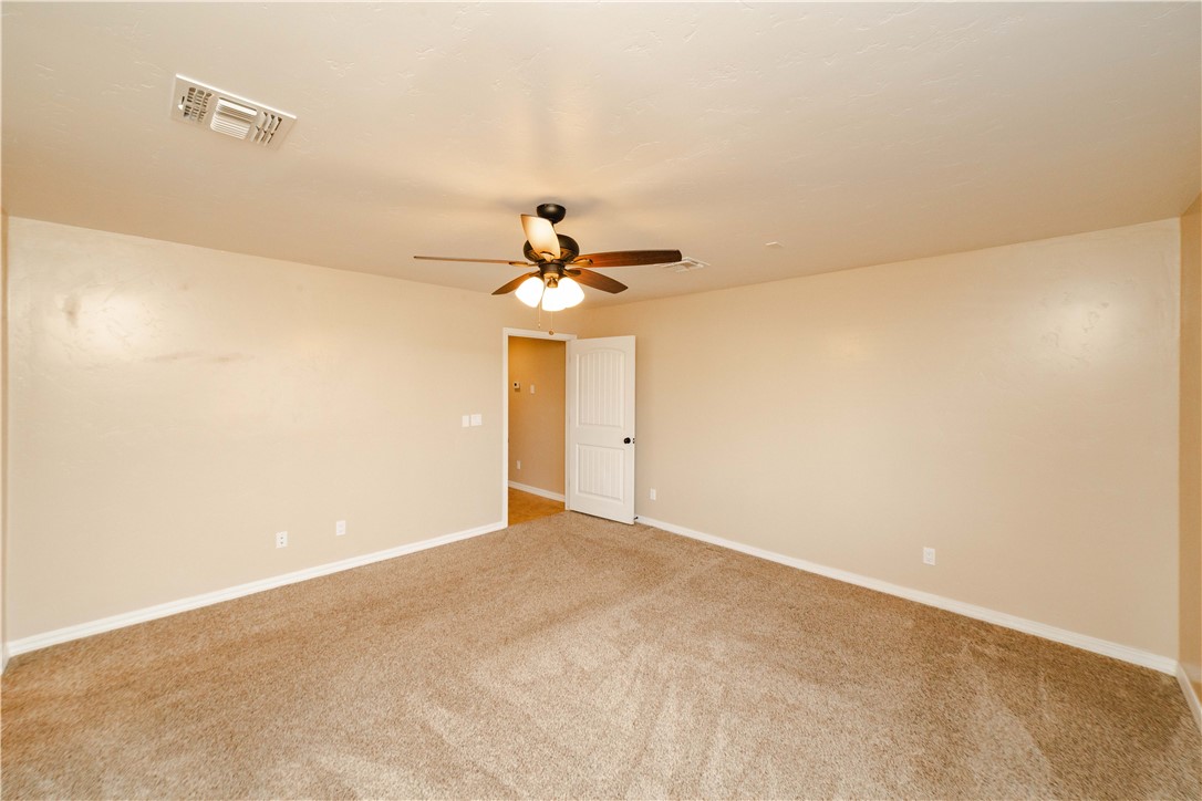 3379 Motherload Road Kingman, AZ 86401 - Photo 23 of 67 Unfurnished room with light carpet and ceiling fan