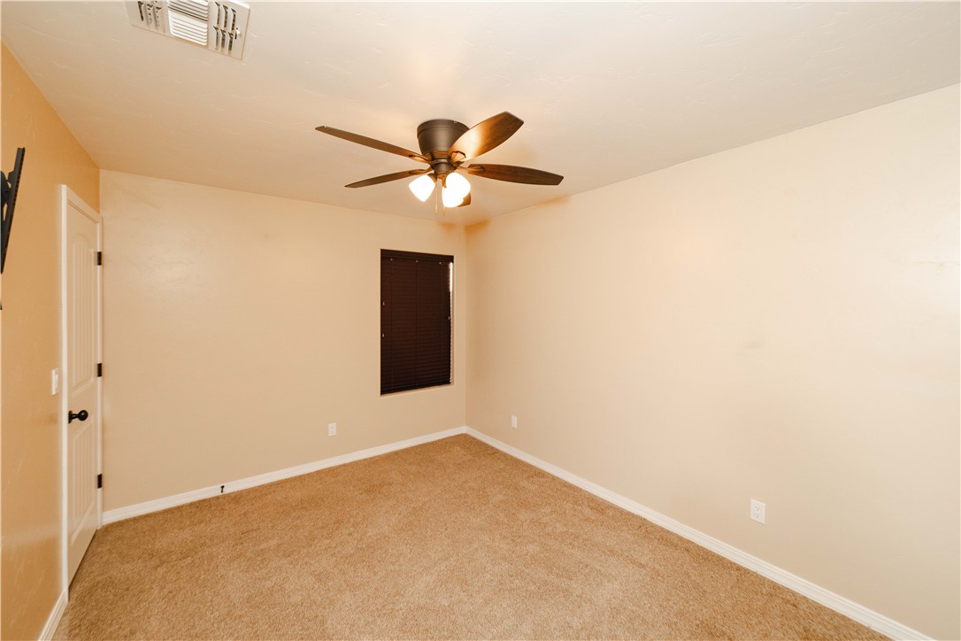 3379 Motherload Road Kingman, AZ 86401 - Photo 30 of 67 Spare room with light colored carpet and ceiling fan
