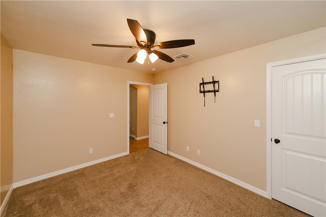 3379 Motherload Road Kingman, AZ 86401 - Photo 32 of 67 Carpeted spare room with baseboards and a ceiling fan