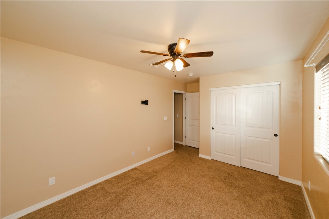 3379 Motherload Road Kingman, AZ 86401 - Photo 37 of 67 Unfurnished bedroom featuring a closet, carpet floors, and a ceiling fan