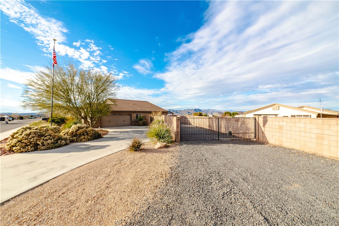 3379 Motherload Road Kingman, AZ 86401 - Photo 53 of 67 View of yard featuring a gate, a mountain view, and concrete driveway
