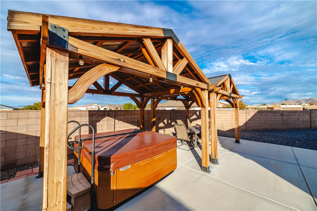 3379 Motherload Road Kingman, AZ 86401 - Photo 61 of 67 Fenced backyard with a patio area and a hot tub
