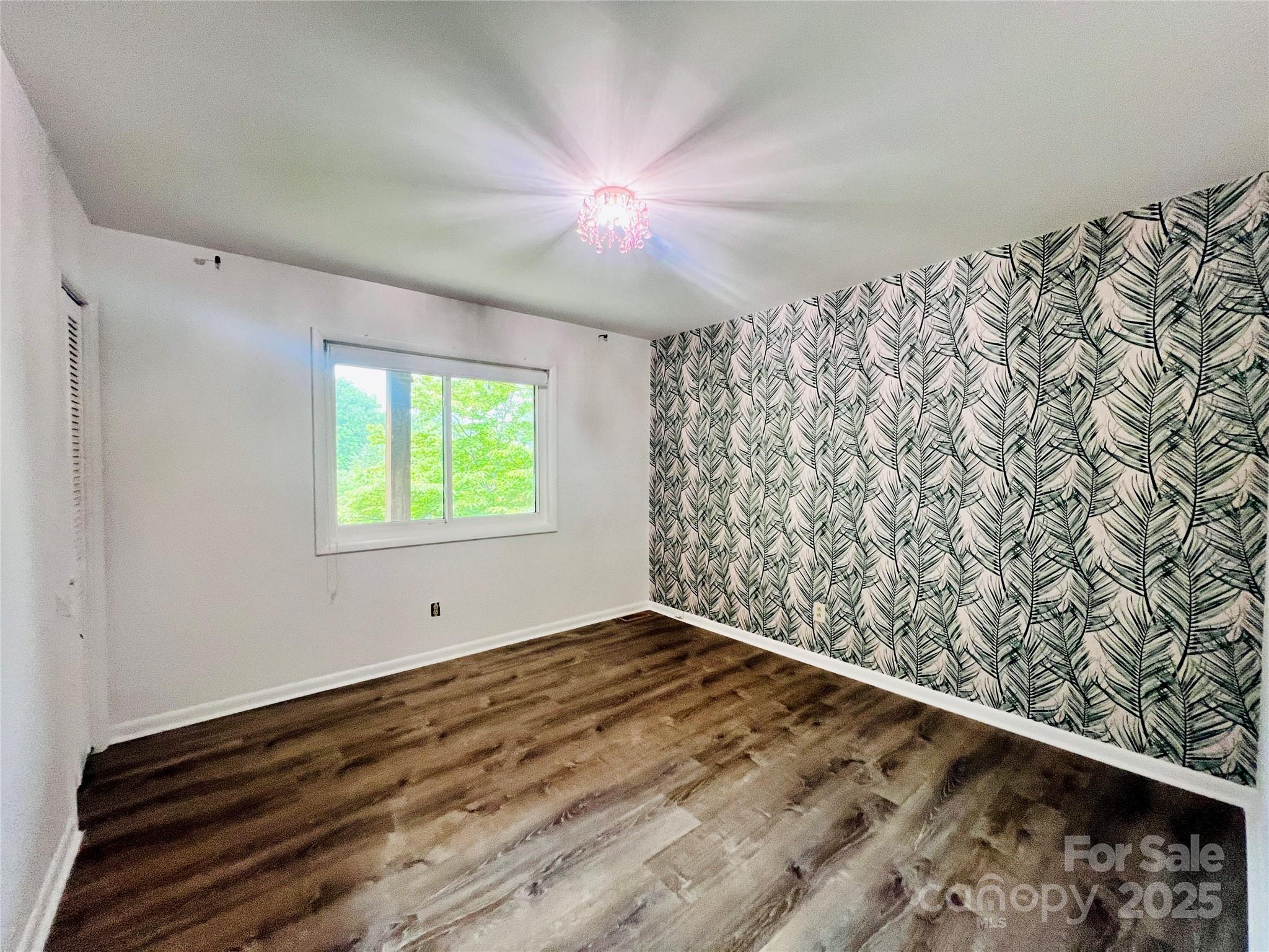9009 Cebu Court Fort Mill, SC 29708 - Photo 22 of 35 a view of an empty room with window and wooden floor