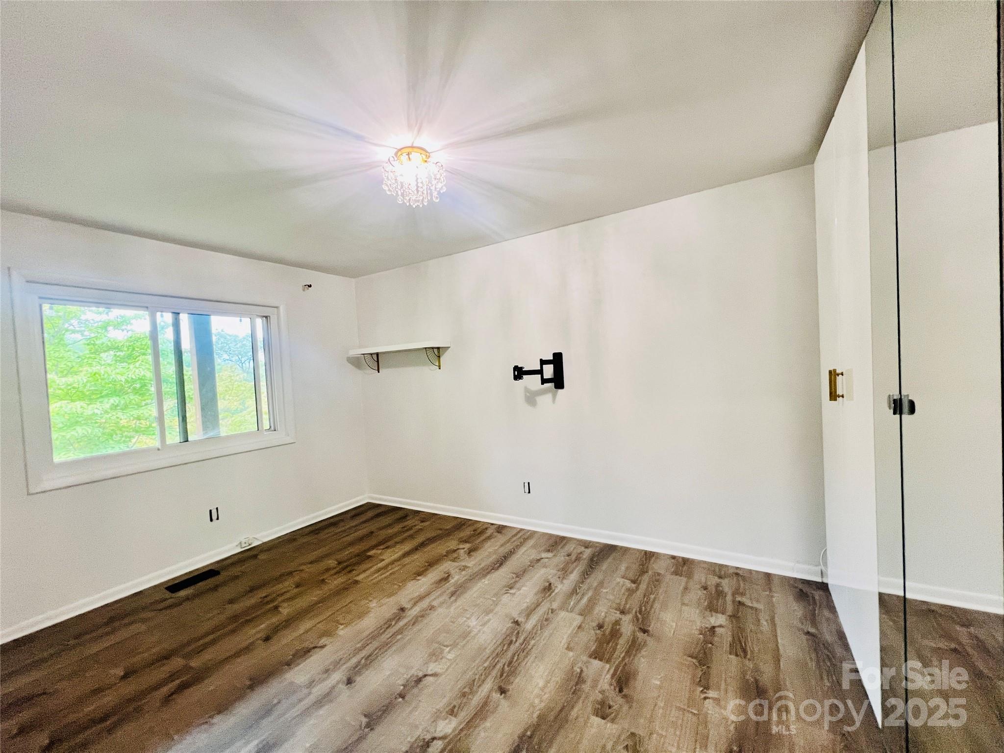 9009 Cebu Court Fort Mill, SC 29708 - Photo 24 of 35 a view of empty room with wooden floor and fan