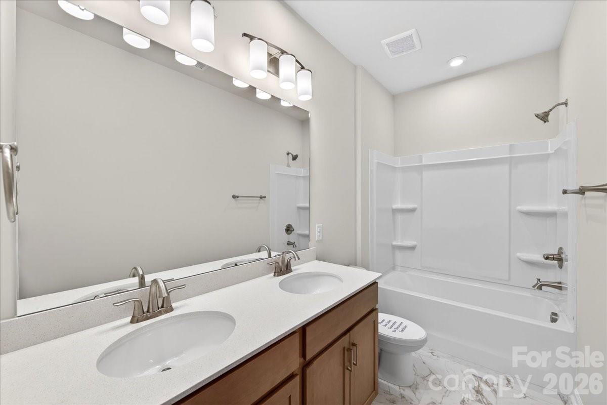512 Webster Lane Cramerton, NC 28032 - Photo 24 of 28 a bathroom with a sink a toilet a mirror a bathtub and shower