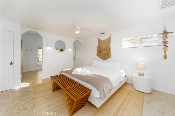 a bedroom with a bed and wall painting