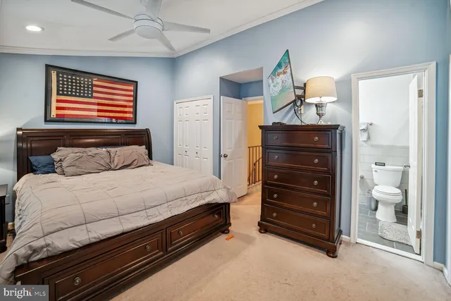 a bedroom with a bed and a mirror