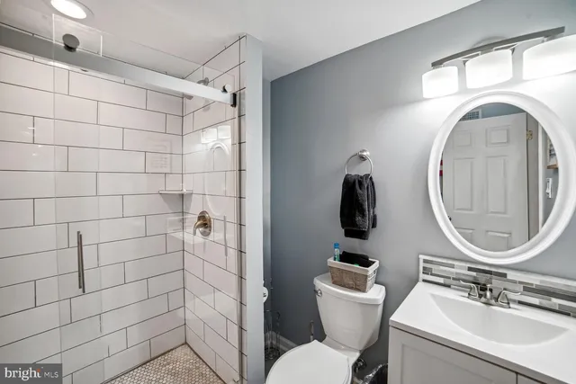 a bathroom with a sink toilet and a mirror
