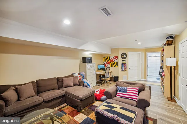 a living room with furniture a couch and a window
