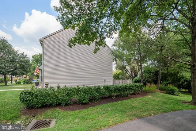 a view of a house with backyard and a tree