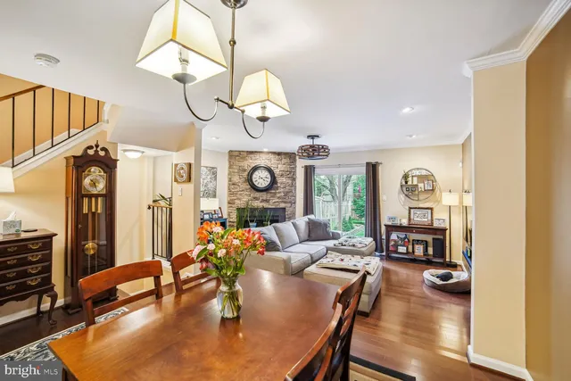 a living room with fireplace furniture and a wooden floor
