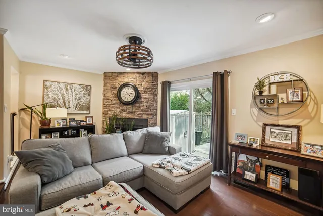 a living room with furniture a rug a window and a chandelier