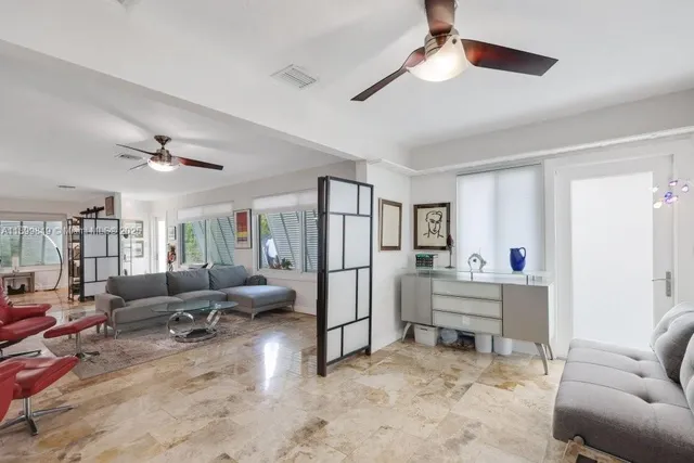 a living room with furniture and a ceiling fan