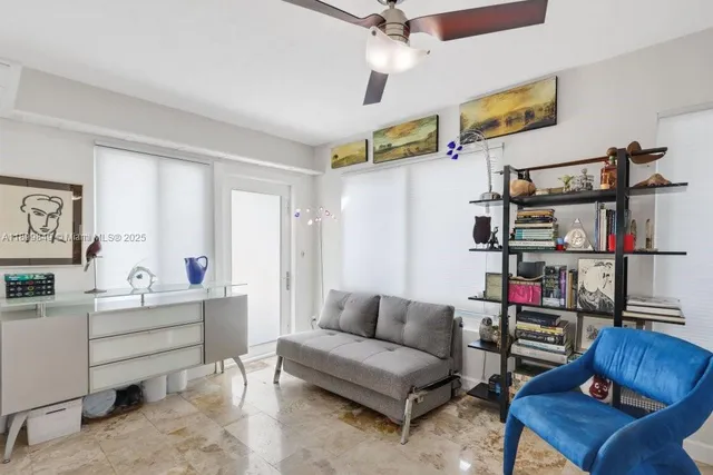 a living room with furniture and a book shelf