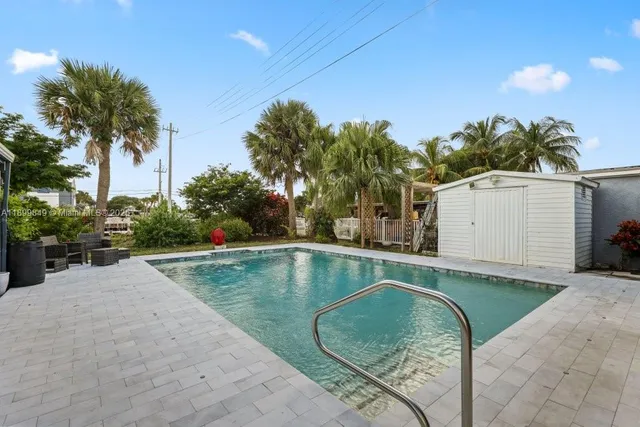 a view of a swimming pool with a backyard