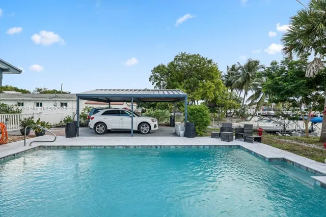 an outdoor view of a house with a garden and entertaining space
