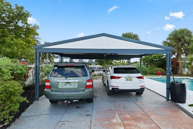 a view of parking and cars parked in a parking