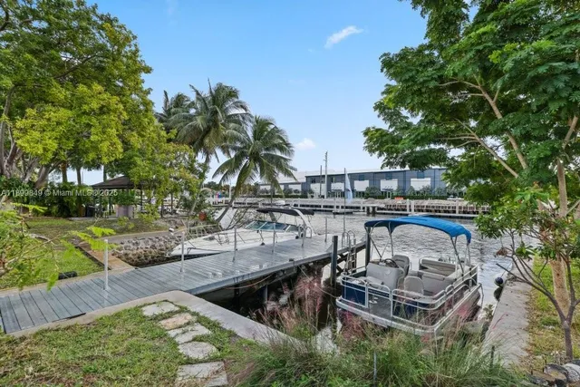 a view of a swimming pool with a patio and a yard