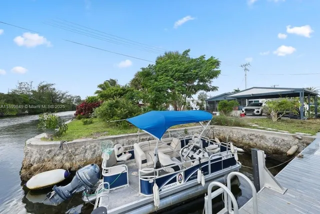 a view of a patio with table and chairs potted plants with wooden floor