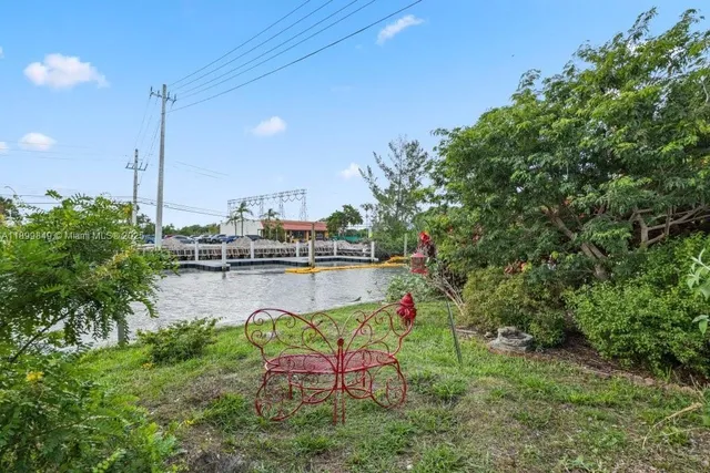 a swimming pool with outdoor seating and yard