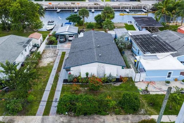an aerial view of multiple houses with yard