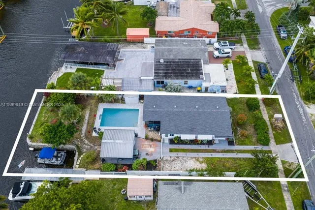 an aerial view of residential houses with outdoor space and street view
