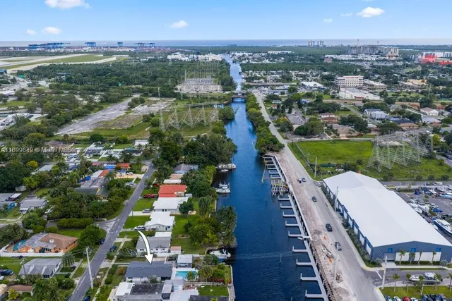 an aerial view of residential houses with outdoor space and river