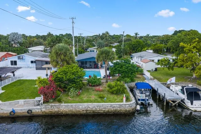 a view of a patio with table and chairs and potted plants