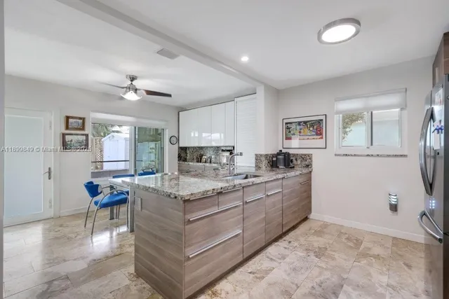 a large white kitchen with a large window