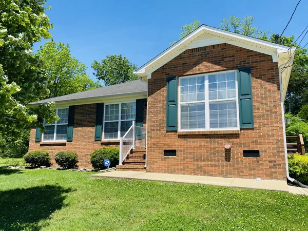 a front view of a house with a yard