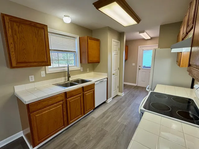 a kitchen with a sink stove and cabinets