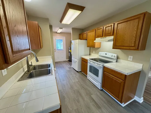 a kitchen with a stove a sink and a refrigerator