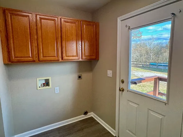 a view of a closet with wooden floor and cabinet