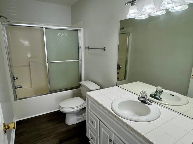 a bathroom with a sink toilet and shower